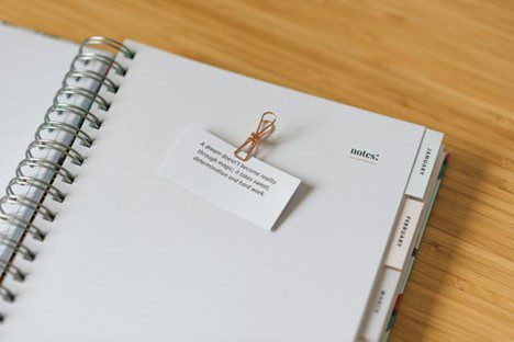 Planner with a paper quote on the first page