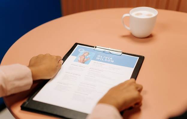 Close up of woman's hands holding a resume