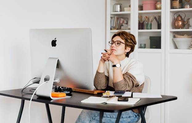 Woman thinking while staring at her computer