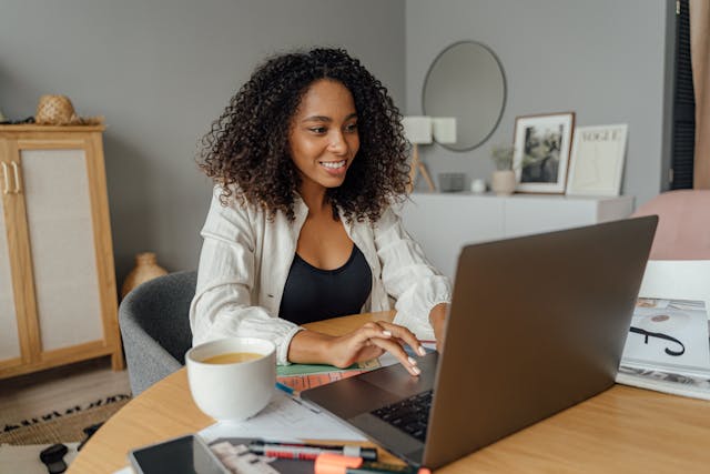 Woman using the laptop while smiling
