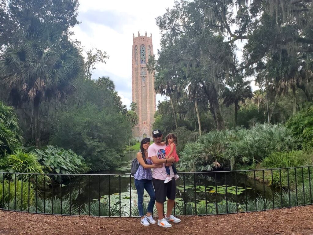 Melissa and family posing front of a tower at Bok Tower Garden