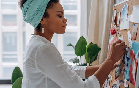 Woman adding image to vision board