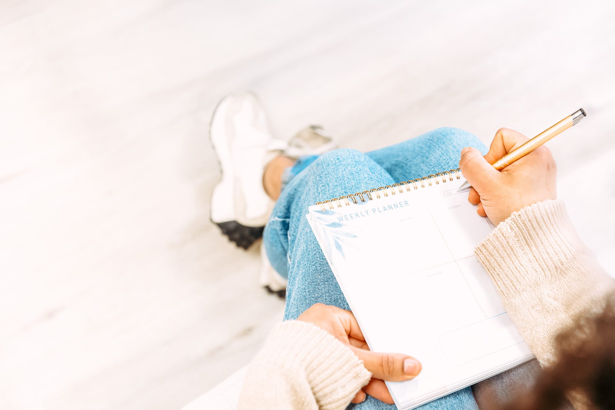 Woman writing in planner