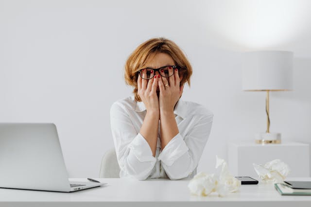 Woman with both hands on her face