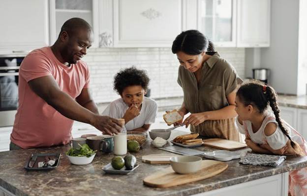 A family eating in the kitchen counter
