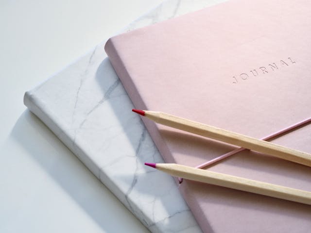Journals with color pencils on top