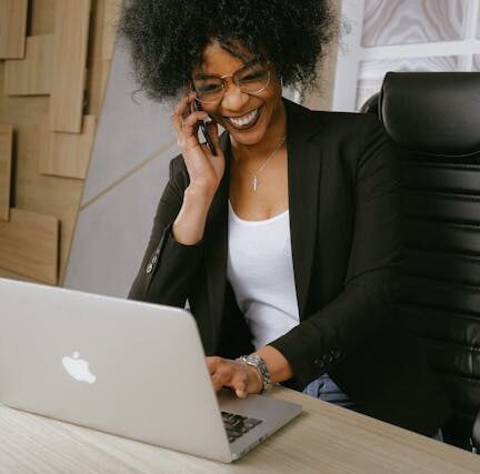 Woman smiling while talking on the phone in office setting