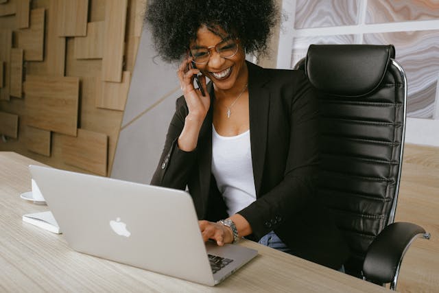 Woman smiling while talking on the phone in office setting