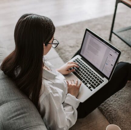 Woman typing in her laptop