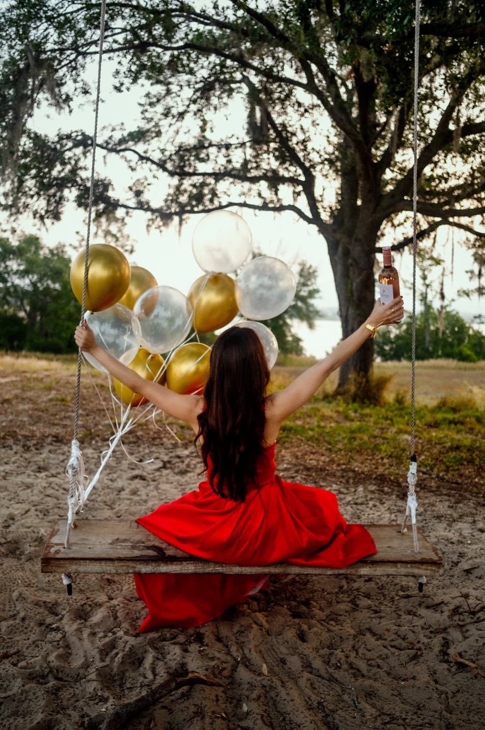 Melissa on a swing in a red dress