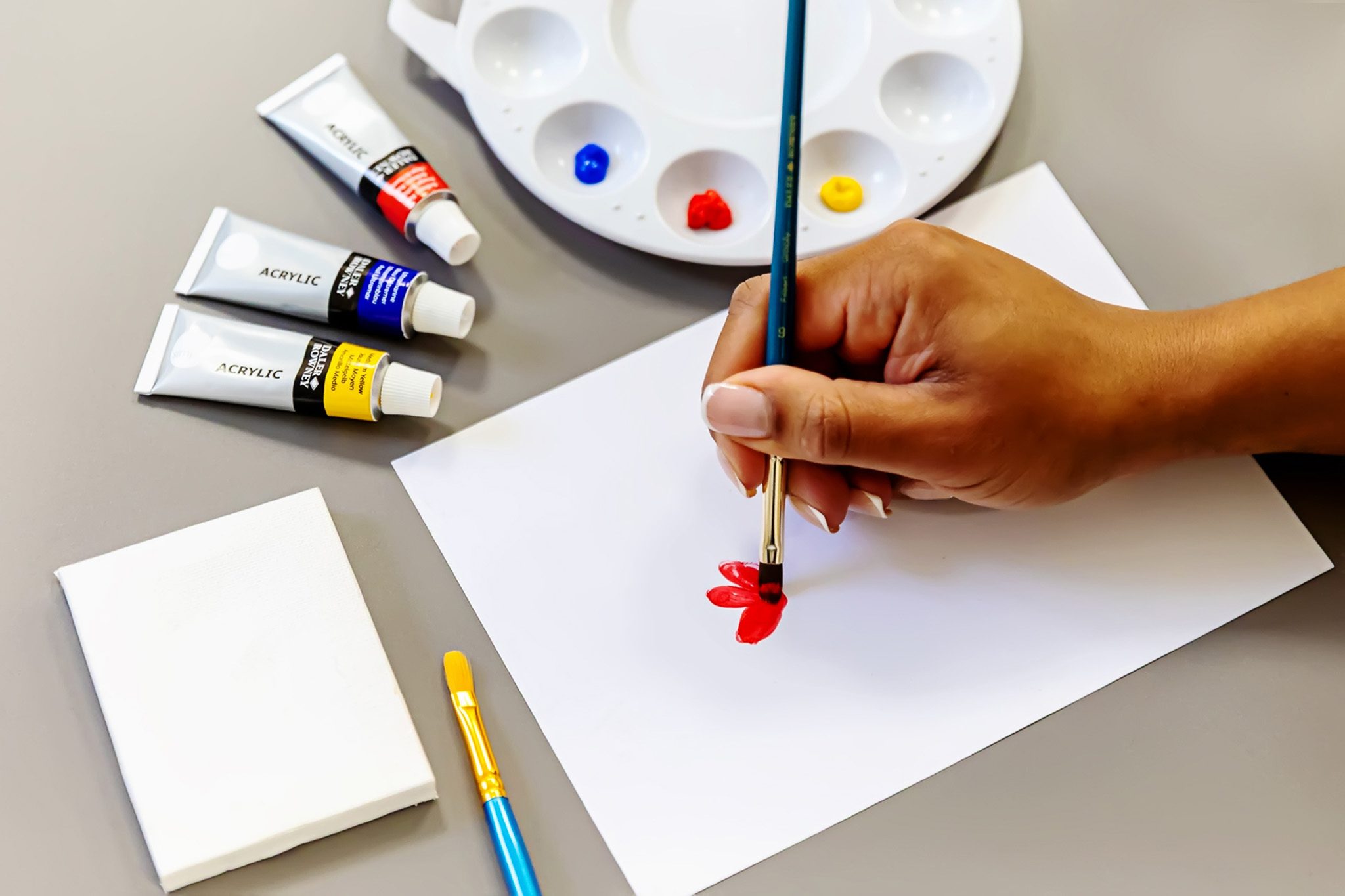Female holding paint brush