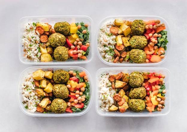 Four open containers filled with food