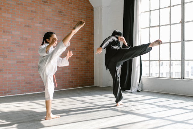 A girl practicing karate with her instructor
