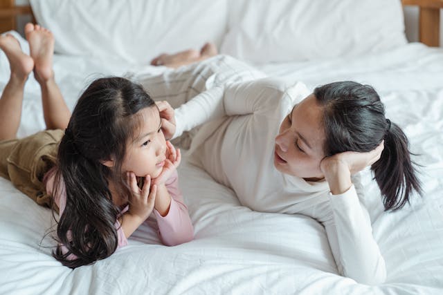 Mom and daughter talking on the bed