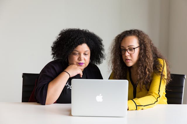 Two women looking at a computer screen