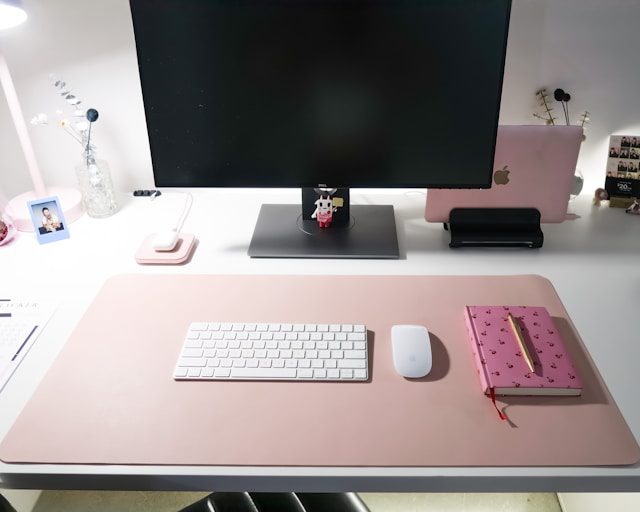 Desk space with computer, iPad, notebook and pencil