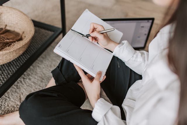 Woman writing in a planner