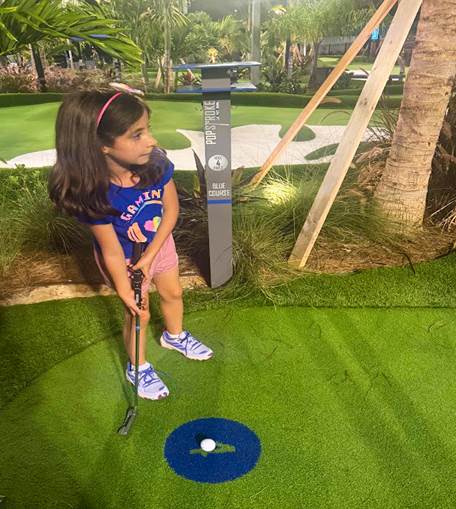 Melissas daughter playing golf