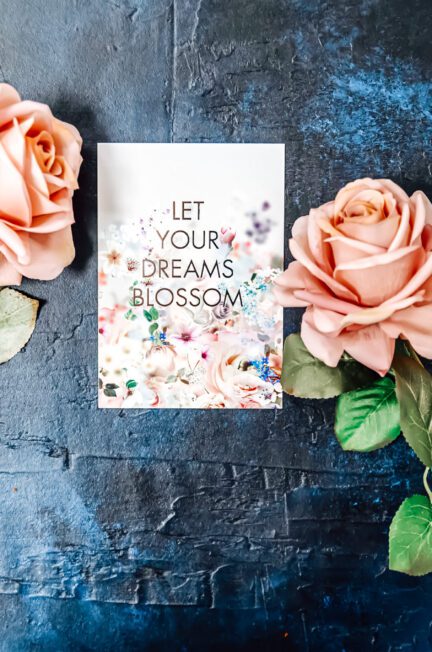 A positive quote with two peach flowers on each side