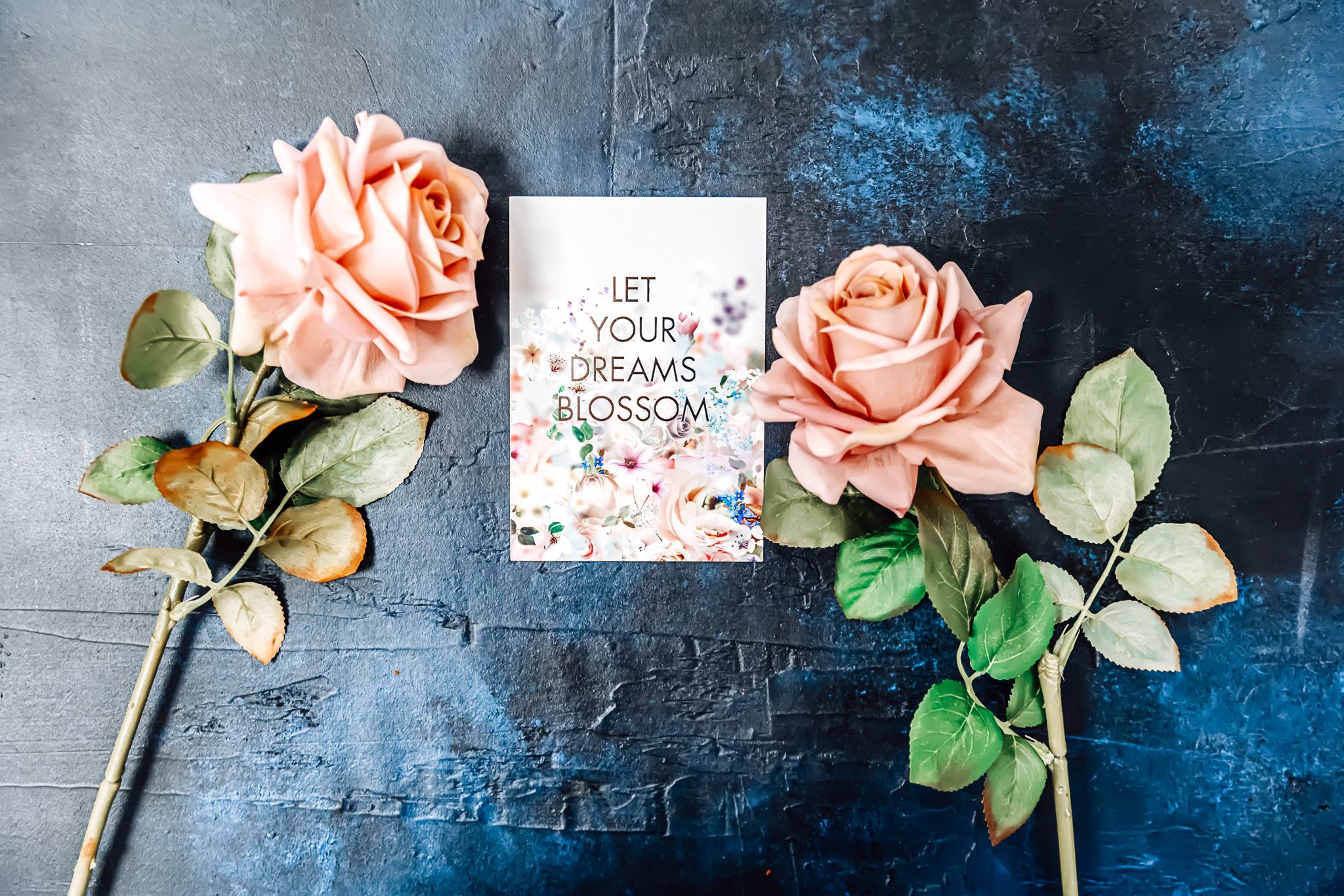 A positive quote with two peach flowers on each side