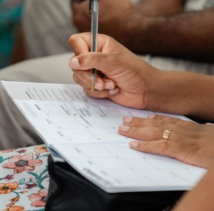 Woman writing on calendar