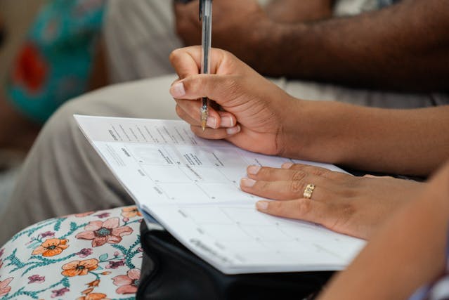 Woman writing on calendar