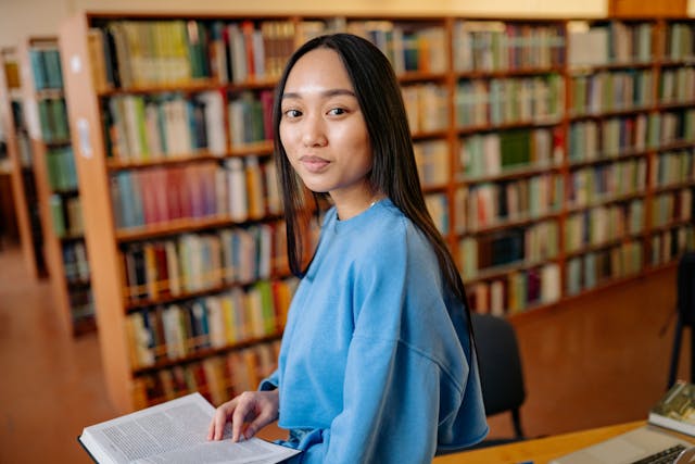 Teen girl smiling in the library
