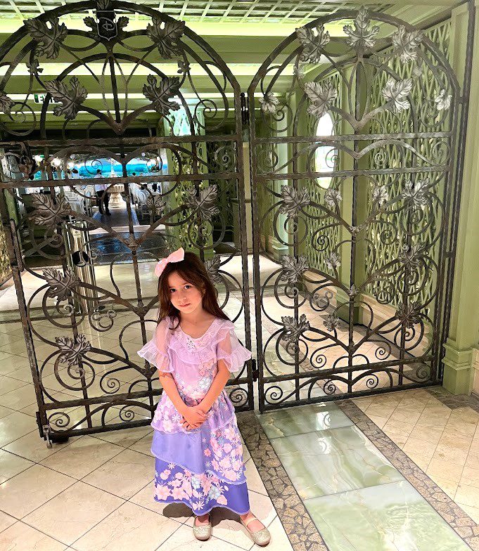 Melissas daughter in front of a Disney cruise restaurant