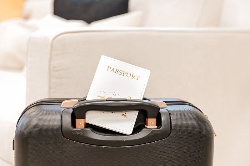 Passport placed on the handle of a suitcase