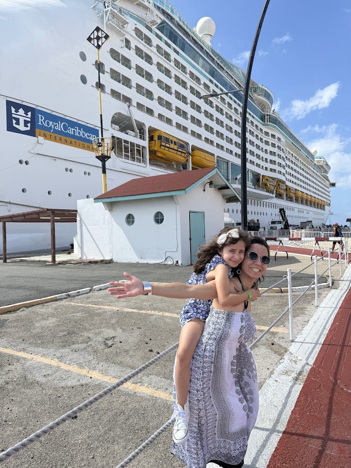 Melissa and daughter posing in front of Explorer of the Seas ship