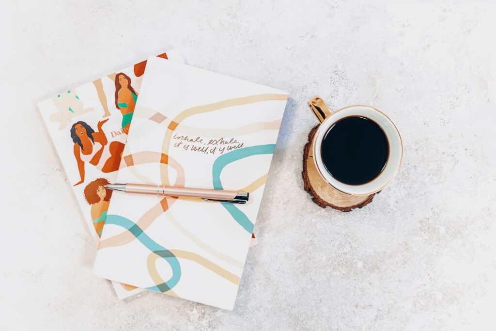 A journal near a cup of coffee