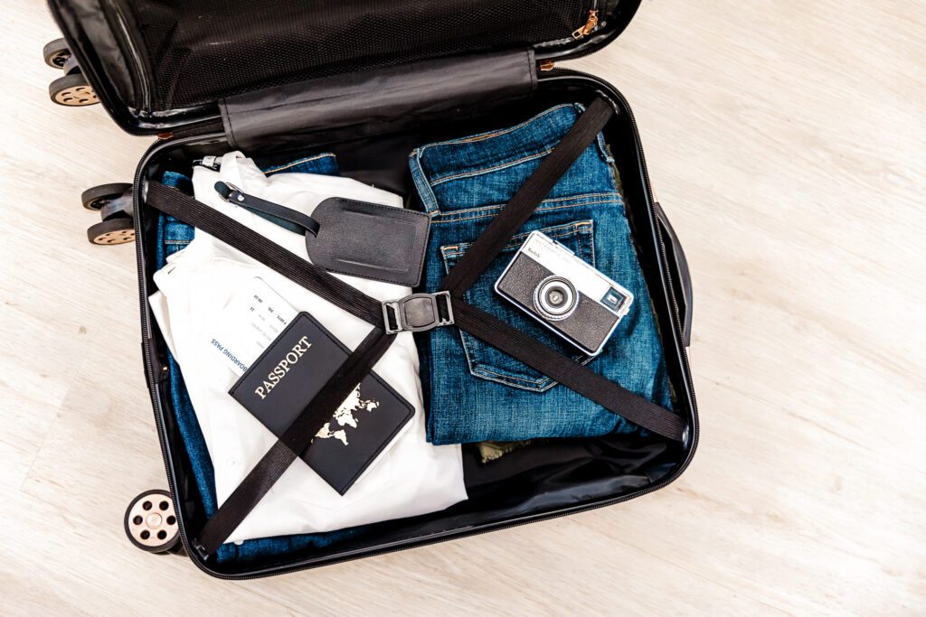 Luggage with clothes, camera, and passport