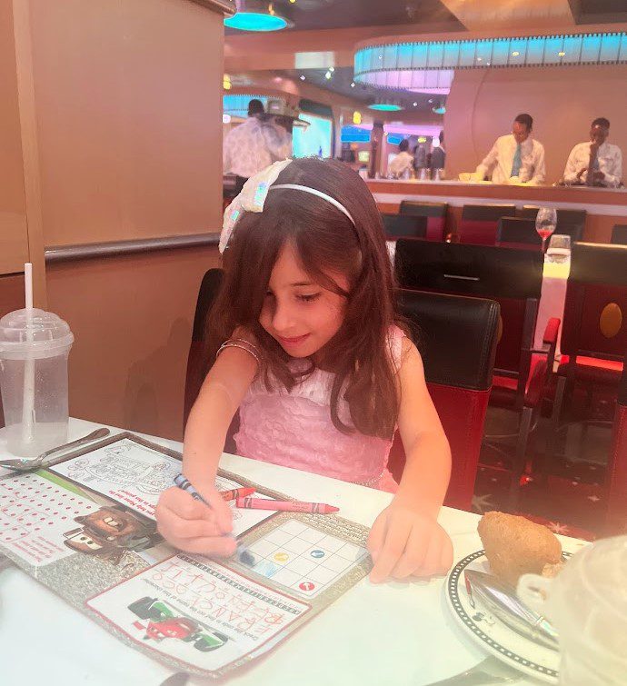 Melissas daughter coloring while waiting for food