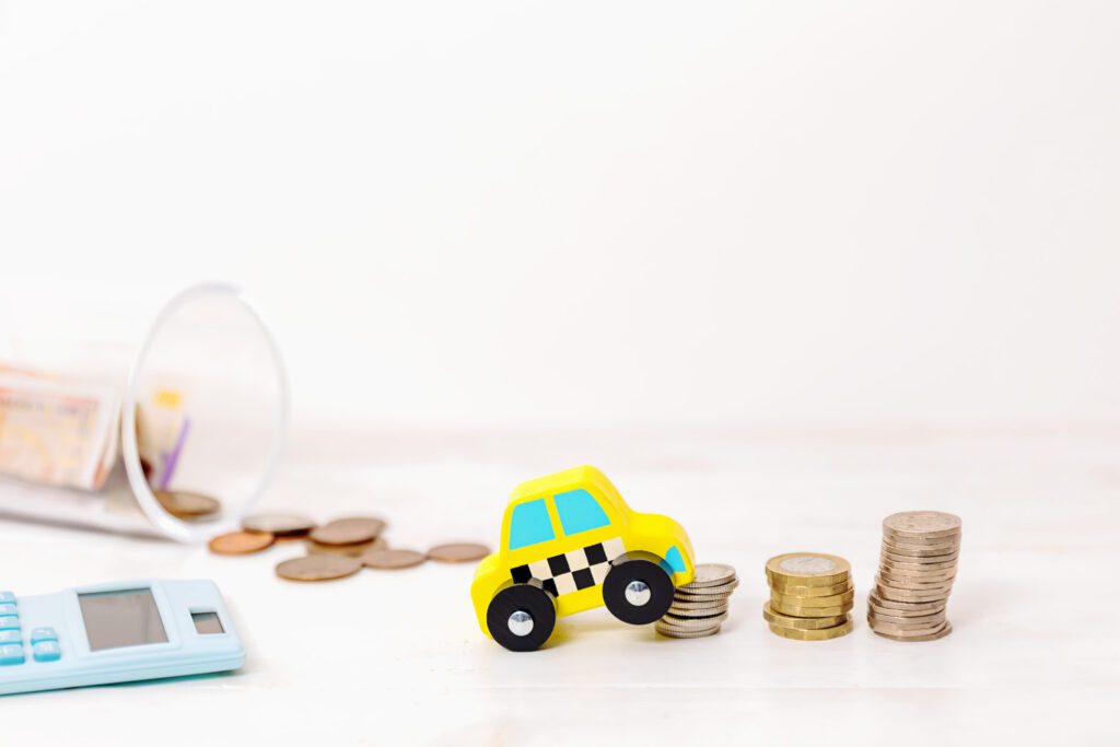 Yellow car going up a stack of toys