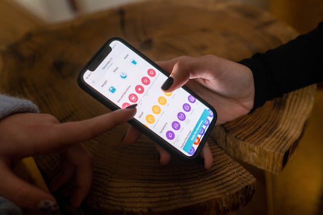 Person holding a smartphone displaying a health app screen