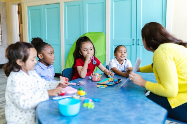 Teacher giving a lesson to young students