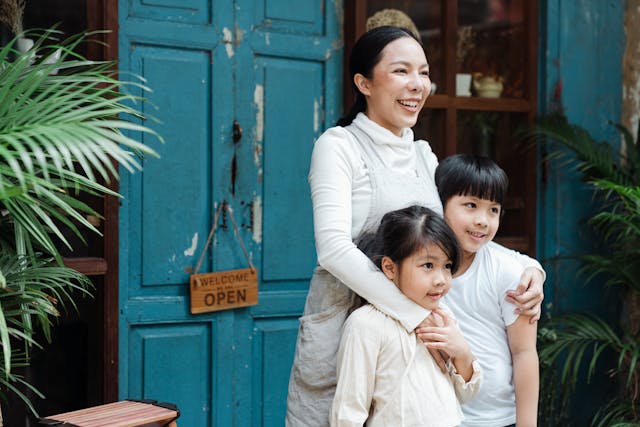 Woman smiling while hugging her children