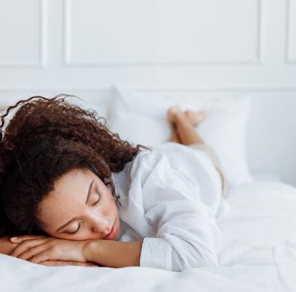Woman resting on bed