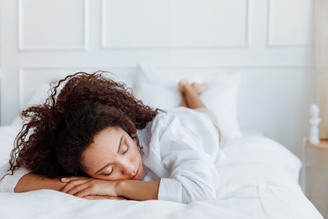 Woman resting on bed