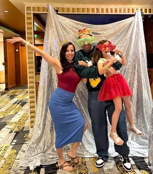 family using photo props in cruise