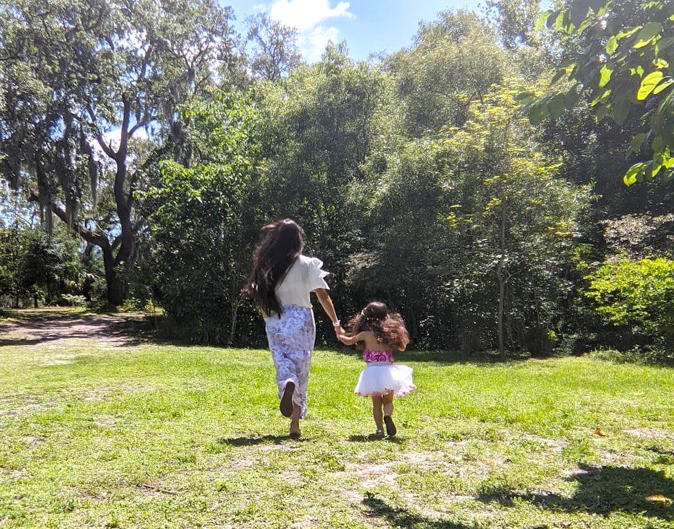 Melissa and daughter running at Mead Botanical Garden