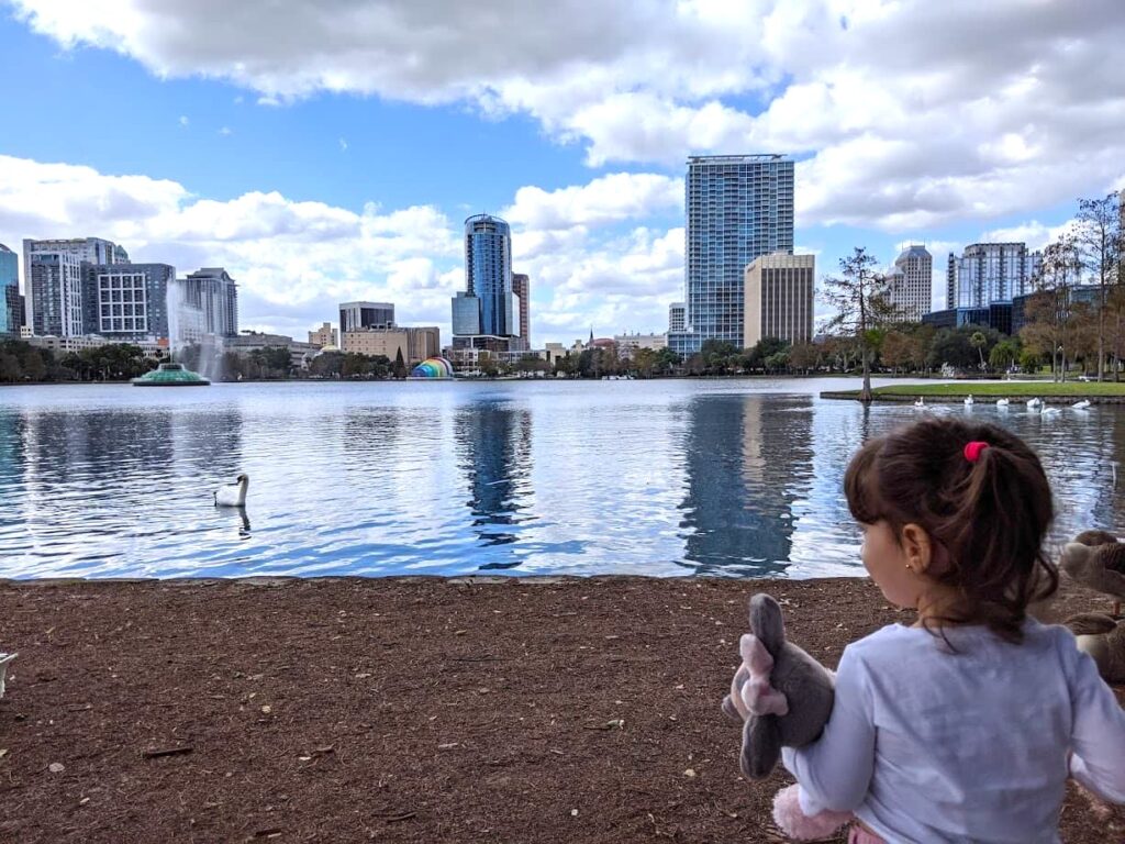 Melissa's daughter looking at buildings at Lake Eola Park