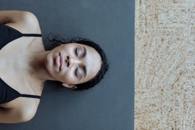 Woman resting on yoga mat