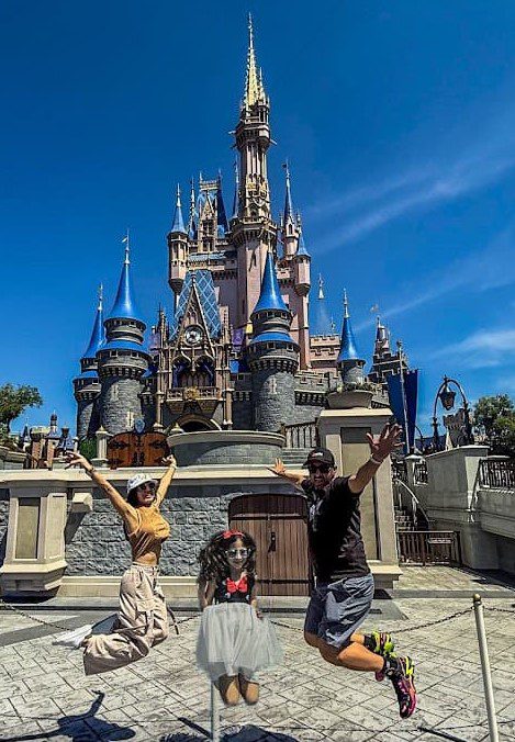 Sarah, Melissa, and husband jumping from of the Disney castle