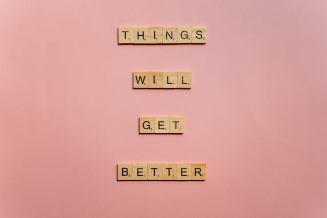 Inspirational quote “Things will get better” on a pink background
