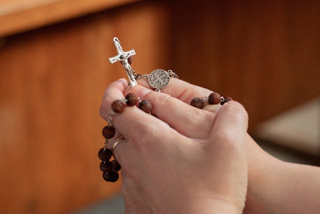 Woman praying with rosary