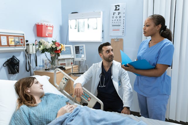 Nurse talking to doctor and patient