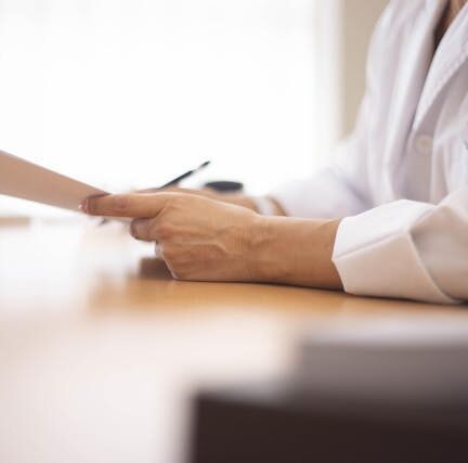 Close up of doctor holding medical record