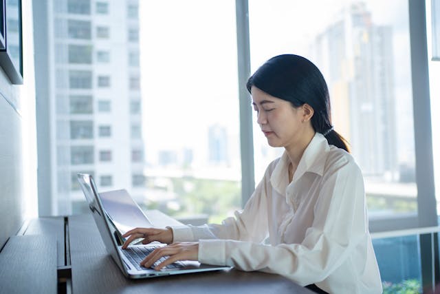 Woman typing in laptop