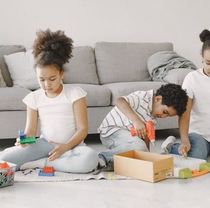 Three kids playing legos